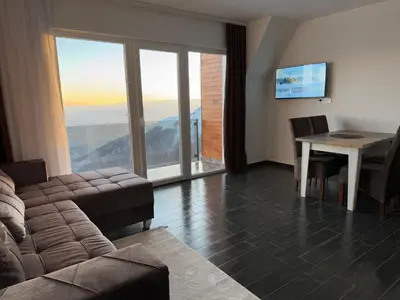 a living room with a couch and a table at Vila Banovic in Kopaonik