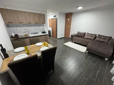 a living room with a table and a couch at Vila Banovic in Kopaonik