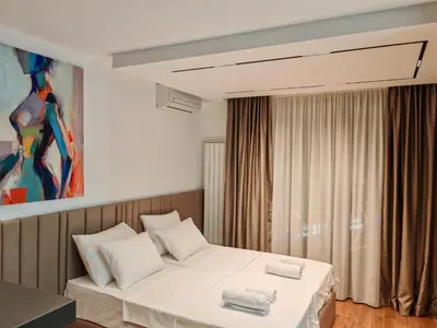 a bedroom with a bed with two towels on it at Planet Lux Apartment with secured parking In the garage in Niš