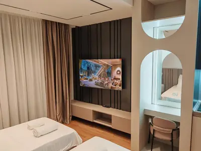 a hotel room with two beds and a mirror at Planet Lux Apartment with secured parking In the garage in Niš