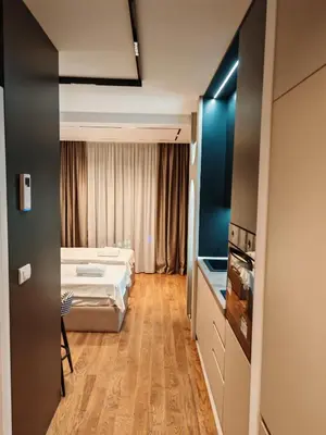 a hotel room with a bed and a window at Planet Lux Apartment with secured parking In the garage in Niš