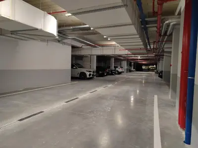 an empty parking garage with cars parked in it at Planet Lux Apartment with secured parking In the garage in Niš