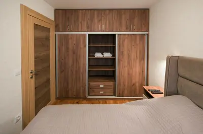 a bedroom with a bed and a cupboard at Apartmani Jovičić Kopaonik in Kopaonik