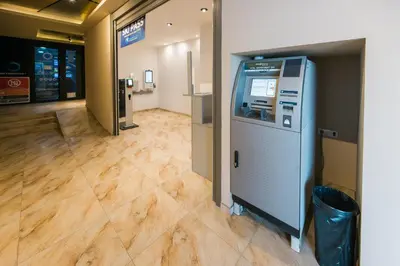 an atm machine in a room with a floor at Apartmani Jovičić Kopaonik in Kopaonik