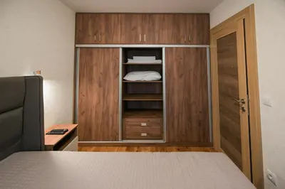 a bedroom with a bed and a cupboard at Apartmani Jovičić Kopaonik in Kopaonik