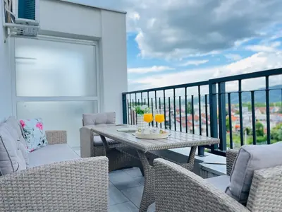 a patio with a table and chairs on a balcony at GOLDEN SS Studio in Vrnjačka Banja