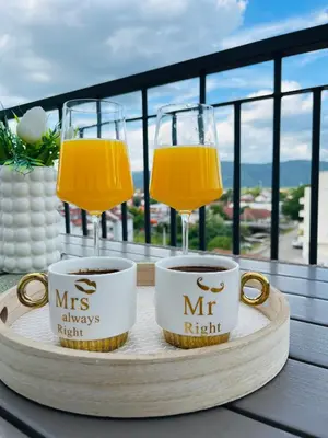 a tray with two cups and two glasses of orange juice at GOLDEN SS Studio in Vrnjačka Banja