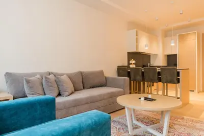 a living room with a couch and a table at Apartman Mimi Zepterme Vrnjačka Banja in Vrnjačka Banja