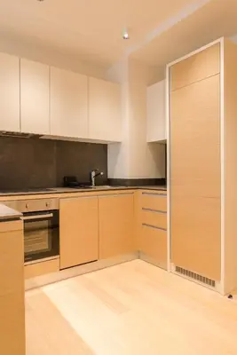 a kitchen with white cabinets and a sink at Apartman Mimi Zepterme Vrnjačka Banja in Vrnjačka Banja