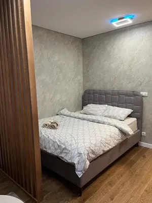 a bed with a pair of shoes sitting on it at Delta SPA Residence in Niš