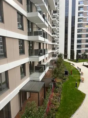 an apartment building with a garden in front of it at Delta SPA Residence in Niš