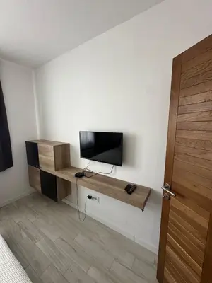 a room with a tv on a wall at Vidik Residence A23 in Kopaonik