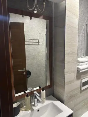 a bathroom with a sink and a mirror at Vidik Residence A23 in Kopaonik