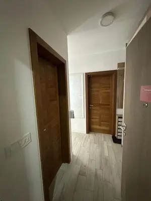 an empty room with a door and a wooden floor at Vidik Residence A23 in Kopaonik