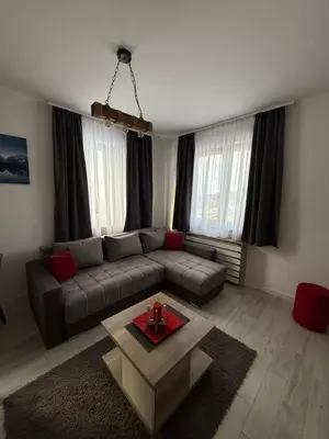 a living room with a couch and a coffee table at Vidik Residence A23 in Kopaonik