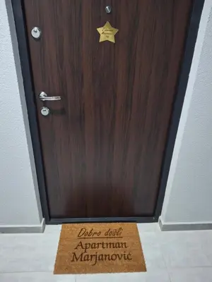 a wooden door with a star sign on it at Apartmani Marjanovic in Jagodina