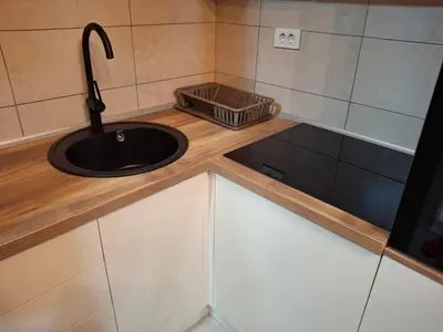 a kitchen counter with a sink and a basket on it at Apartmani Marjanovic in Jagodina
