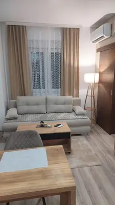 a living room with a couch and a table at Apartmani Marjanovic in Jagodina