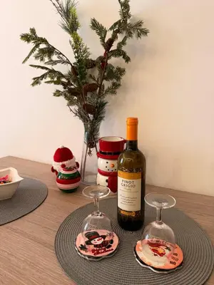 a bottle of wine and two glasses on a table at Woodland B65 Residence Hill Kopaonik in Kopaonik