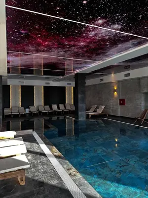 a large swimming pool with a star system on the wall at Woodland B65 Residence Hill Kopaonik in Kopaonik