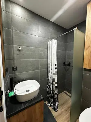 a bathroom with a sink and a shower at Woodland B65 Residence Hill Kopaonik in Kopaonik