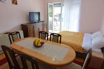 a room with a table with a bowl of fruit on it at Apartman Nidža in Vrnjačka Banja
