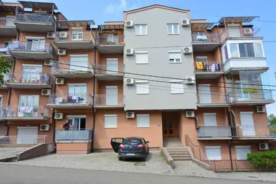 a car parked in front of a building at Apartman Nidža in Vrnjačka Banja