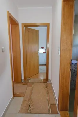 a hallway of a room with a door and a floor at Apartman Nidža in Vrnjačka Banja