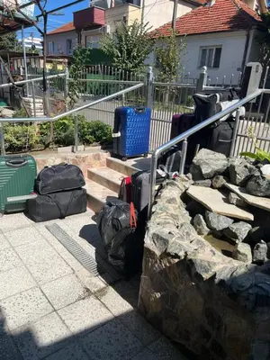 a group of bags sitting on the ground next to some stairs at Slobo Velickovic in Prokuplje