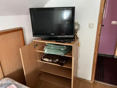 a television sitting on top of a wooden cabinet at Slobo Velickovic in Prokuplje