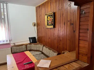 a room with a table and a wooden wall at Slobo Velickovic in Prokuplje