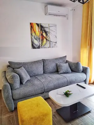 a living room with a couch and a table at Moj Mir in Vrnjačka Banja
