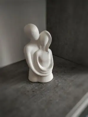 a white figurine of two people sitting on a table at Moj Mir in Vrnjačka Banja