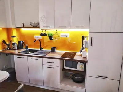 a kitchen with white cabinets and a white refrigerator at Moj Mir in Vrnjačka Banja
