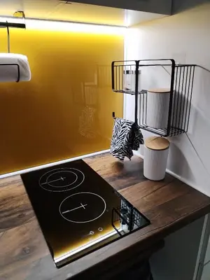 a kitchen with a stove top in a room at Moj Mir in Vrnjačka Banja