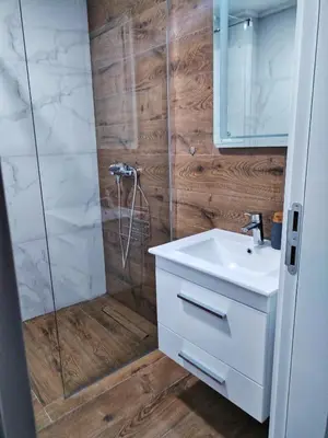 a bathroom with a white sink and a shower at Moj Mir in Vrnjačka Banja