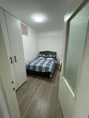 a bedroom with a bed in a small room at Apartman Anastasija in Kuršumlija