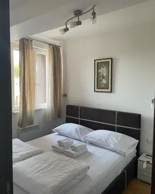 a bedroom with a bed with two towels on it at Kraljevi Čardaci apartman Lux 10 in Kopaonik