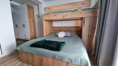 a bedroom with a bed with a wooden headboard at The View A74 in Raška