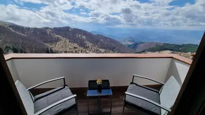 two chairs and a table on a balcony with a view at The View A74 in Raška