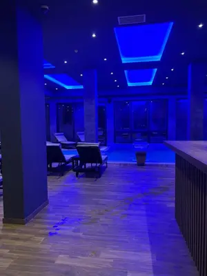 an empty room with blue lights on the ceiling at The View A74 in Raška