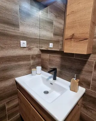 a bathroom with a white sink and a mirror at The View A74 in Raška
