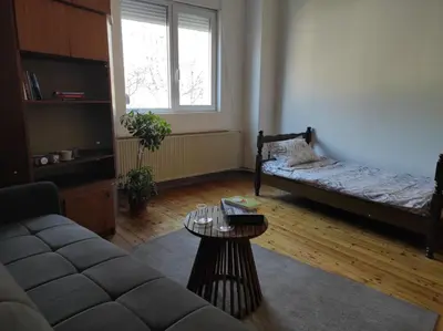 a living room with a couch and a table at Dona Rooms 4 in Niš