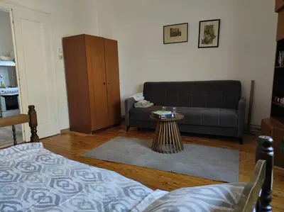 a living room with a couch and a table at Dona Rooms 4 in Niš