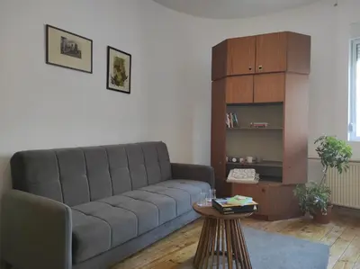 a living room with a couch and a table at Dona Rooms 4 in Niš