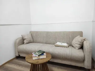 a living room with a couch and a table at Dona Rooms 5 in Niš