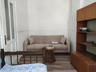 a living room with a couch and a table at Dona Rooms 5 in Niš