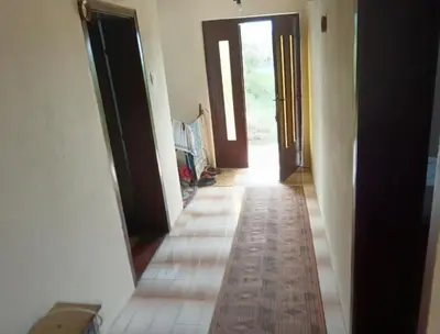 a hallway with two doors and a tile floor at Milutovac in Trstenik