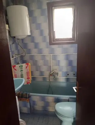 a bathroom with a tub and a toilet and a sink at Milutovac in Trstenik