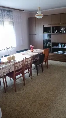 a dining room with a table and some chairs at Milutovac in Trstenik